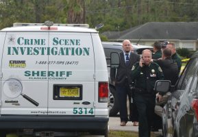 Sheriff Staly at the scene of the Seamanship Trail shooting last week, with detectives and command staff behind him. Click on the image for larger view. (© FlaglerLive)