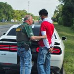 Sheriff Rick Staly arresting the Palm Coast man for speeding in excess of 120 mph on I-95. Staly was on his way to dinner with his wife, who was in the car, and who took this picture.