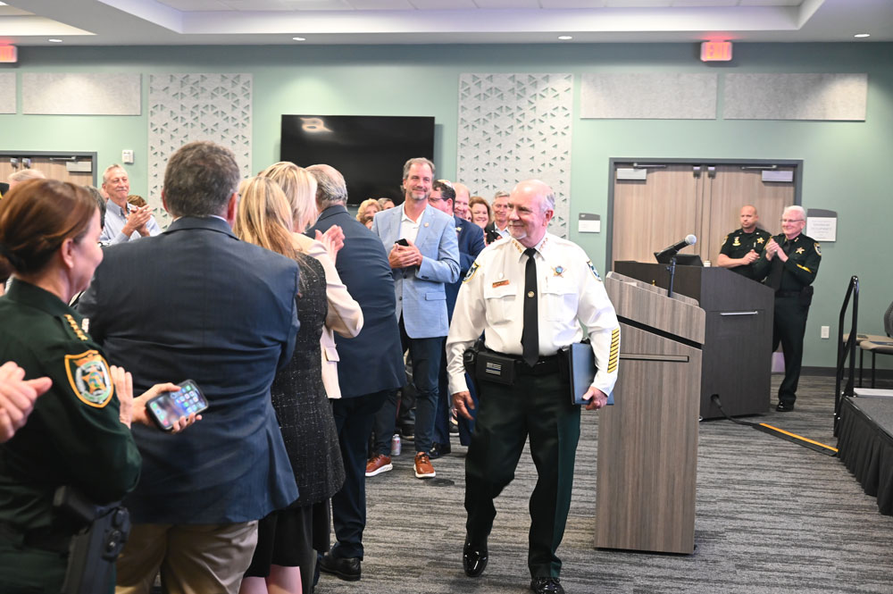 The sheriff walked in to a standing ovation. (© FlaglerLive)