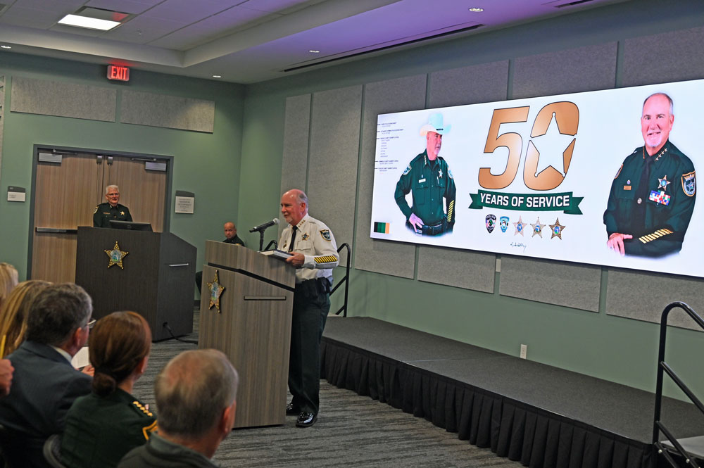 Accepting one of many honors. (© FlaglerLive)