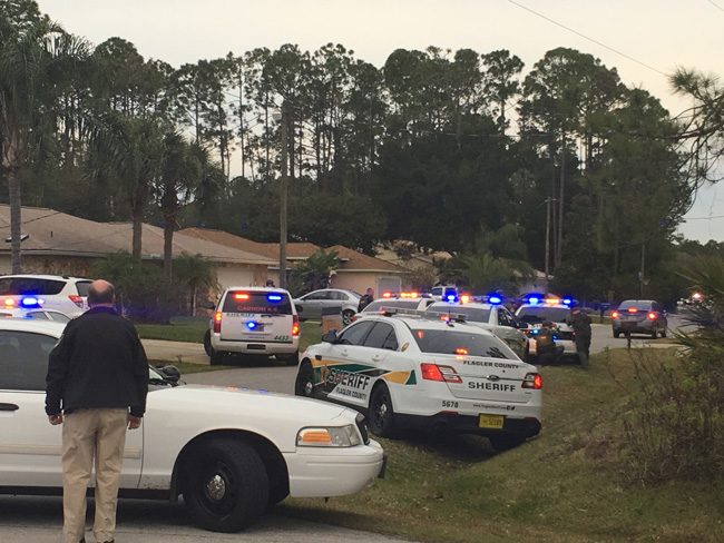 Some 20 Flagler County Sheriff's units  have surrounded a suspect in a stolen vehicle in Palm Coast's B Section in a standoff that began in late afternoon. The suspect is in the vehicle to the right. The vehicle has been idling throughout. Sheriff Rick Staly, to the left, is at the scene with much of his command staff. (FCSO)