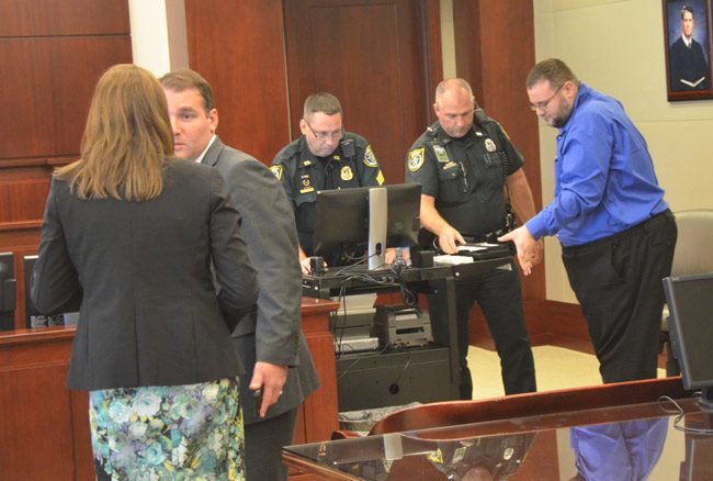 Michael Stavris getting finger-printed after his first prison sentence in 2016. (© FlaglerLive)