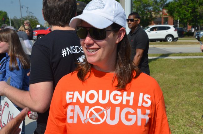 Stephanie Capehart, who organized the demonstration, wore the colors of Wear Orange, the gun-control advocacy group. Click on the image for larger view. (© FlaglerLive)