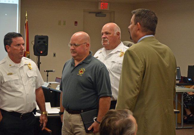 Stephen Palmer, second from left, authored the letter to County Commission Chairman Don O'Brien regarding the firefighters' union's no-confidence vote in County Administrator Craig Coffey, right. Palmer and Coffey are seen here at a 2017 meeting, with Fire Chief Don Petito, left, and now-retired Bunnel Fire Chief Ron Bolser. (© FlaglerLive)