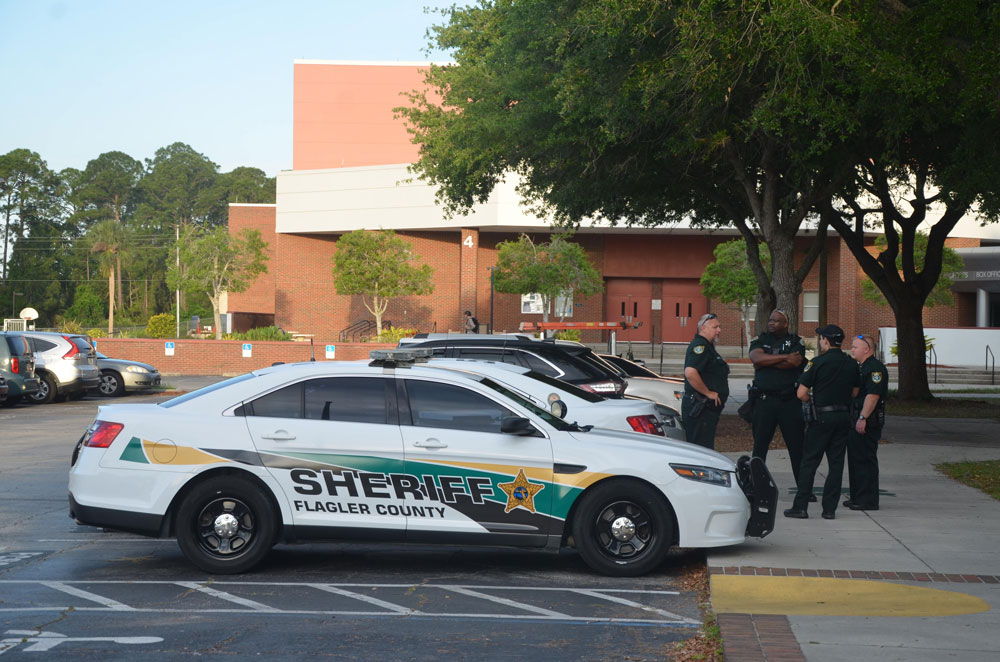 The now familiar sight of stepped-up police presence whenever social media chatter alludes to a threat at a local school. The scene above dates back to one such threat at FPC two years ago. (© FlaglerLive)