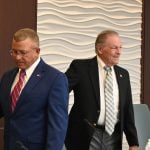 Ray Stevens, right, getting ready to take his seat after his swearing in in November 2024. next to Mayor Mike Norris. (© FlaglerLive)