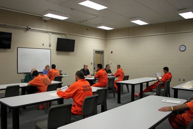 Inmates during a Stride Program orientation last week at the Flagler County jail, with program director Becky Quintieri. The program has seen 390 inmates in a little over six months. Non-violent offenders are eligible. (FCSO)