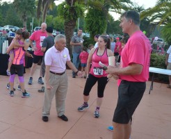 Flagler County School Board member John Fischer, showing thumbs up for the cause, with Florida Hospital Flagler's John Subers, right, the chief styrategist and organizer of the Pink Army. Click on the image for larger view. (© FlaglerLive)