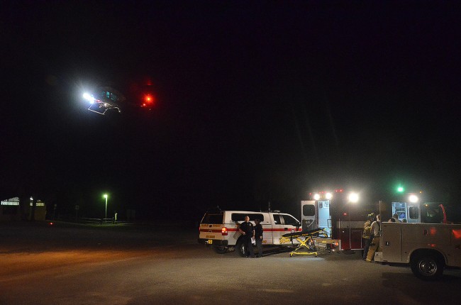 Volusia County's Air One rescue helicopter lifts off at 9:56 p.m. from the parking lot of the Moody Boat Launch at the foot of the Flagler Beach bridge, with a man called 'Jim' on board. Click on the image for larger view. (© FlaglerLive). 