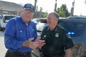 Sheriff Staly 'arresting' County Commissioner Dave Sullivan in a fund-raising stint last March. If Staly had caught Sullivan with a small amount of pot, even in a first offense, the arrest would have been for real. (© FlaglerLive)