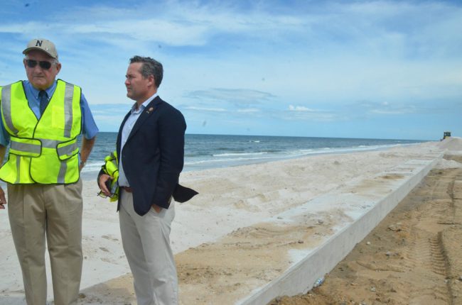 County Commissioner Dave Sullivan, left, with Waltz on the completed 5,000-foot sea wall at the north end of Flagler Beach. (© FlaglerLive)