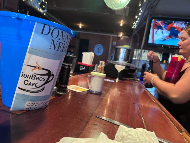The donation bucket for SunBros at the Anchor in Flagler Beach. (© FlaglerLive)
