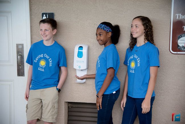 Last week Bunnell Futiure Problem Solvers Ryan Gilvary (left, DeErra Jones, and Aliyah Acevedo installed sunscreen dispensers at Bings Landing and Wadsworth Park. The group presented the idea to the County Commission on March 4. (Flagler Schools)