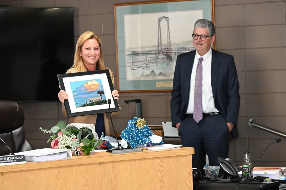 Sunset for Mayor Suzie Johnston: the one-term mayor received a bunch of roses from the city and a sunset from Scott Spradley, a photographer, who was elected chair of the commission Thursday evening in a rare change of tradition. (© FlaglerLive)