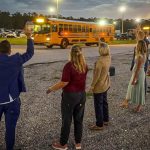 Flagler Schools superintendent LaShakia Moore, right, and others hailed the new school year this morning, greeting the first bus run at dawn. (Flagler Schools)