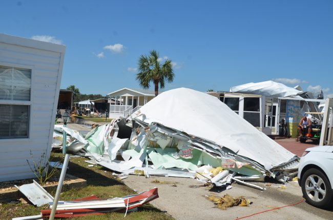 At Surfside Estates, the mobile home community in beverly Beach, whole roofs were ripped off and slammed into the street, but the more extensive damage, which struck most homes, was the flooding. Tim Arnold, above, is sitting by the damaged house his fiancee Lorri Benson owns. Click on the image for larger view.b (c FlaglerLive)