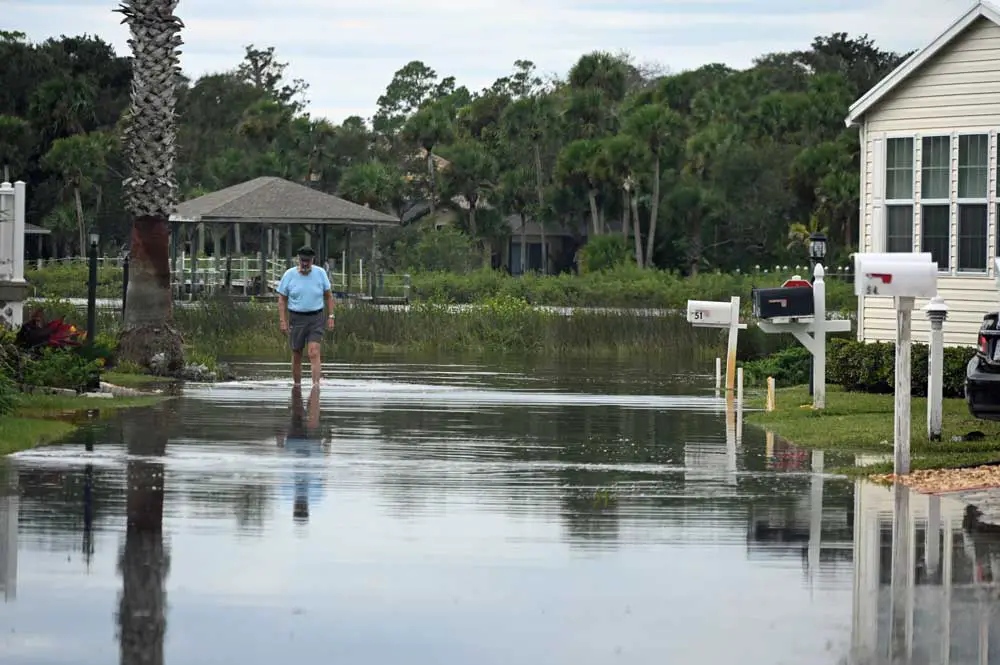 A resident of Surfside Estates, the manufactured home community in beverly Beach, this afternoon. Surfside Estates suffered heavy damage in the aftermaths of Matthew and Irma, but considerably less so with Hurricane Ian, some flooding of streets aside. (© FlaglerLive)