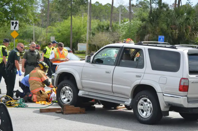 The SUV had to be lifted to pull Pinero out from under it. (c FlaglerLive)