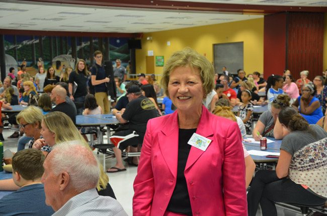 Suzanne Johnston, Flagler County's tax collector, was at the Flagler Youth Orchestra Open House Wednesday evening, making a $1,325 donation to the program--money her office raised with tip jars for a month. Johnston has raised money for the program for the past several years. The program is drawing an enrollment of some 400 students. (© FlaglerLive)