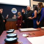 Bunnell Police Chief Dave Brannon, flanked by his family, was sworn in last Monday by County Judge Andrea Totten. (© FlaglerLive)