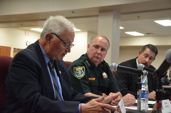 Robert Sweeney, left, presenting his analysis of a county report on the Sheriff's Operations Center at a County Commission workshop today, with Sheriff Rick Staly and County Administrator Craig Coffey. (© FlaglerLive)