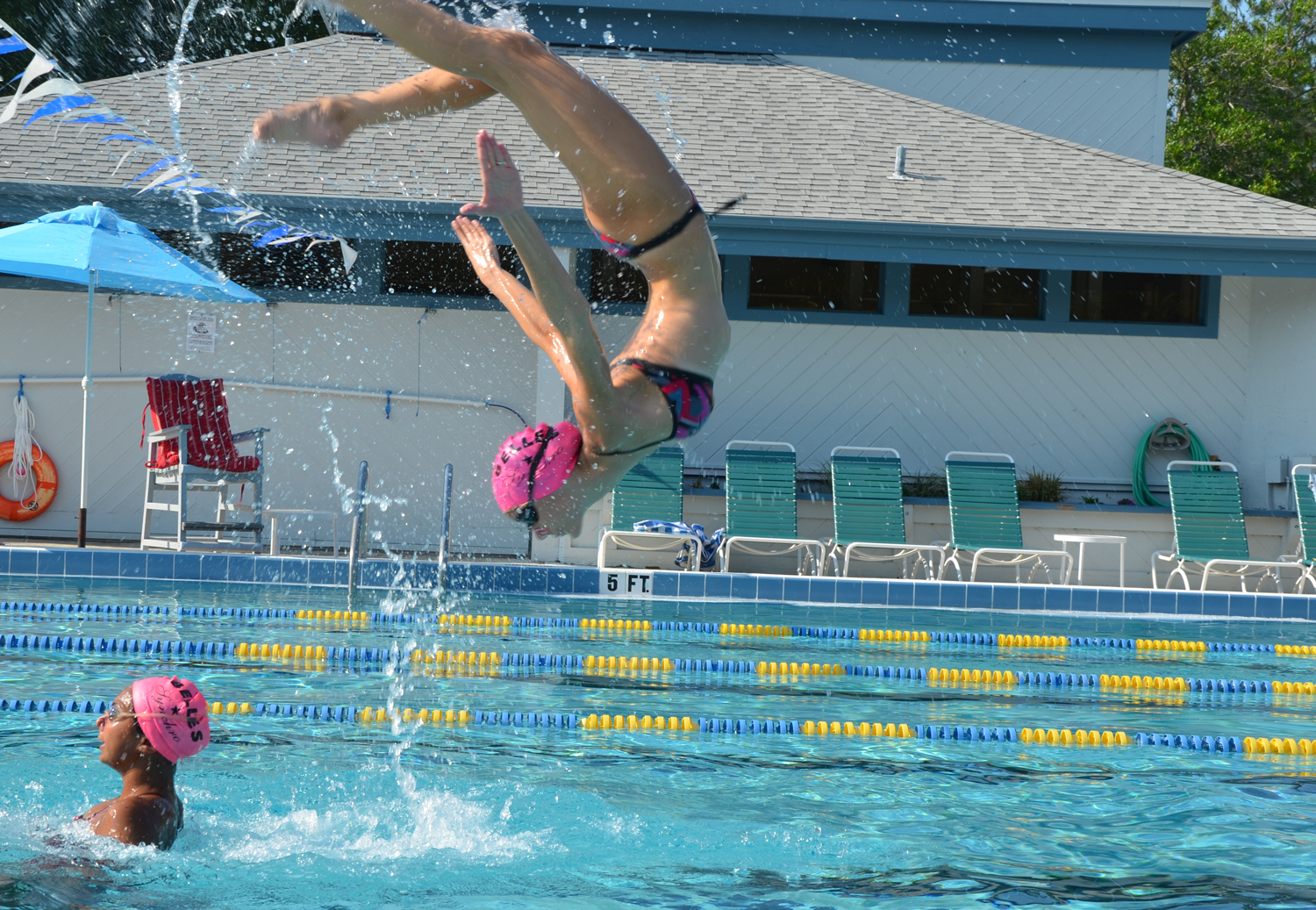 The Flagler County Synchro Belles' Carrie Hartnett flips out in a maneuver she executes with Alexis Solomon. Click on the image for larger view. (© FlaglerLive)