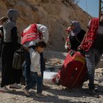 Lebanese aid workers help Syrian refugees at the Masnaa border crossing in Bekaa Valley.