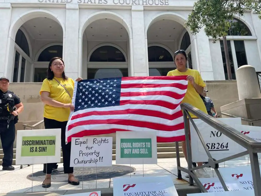 Opponents of a new state law restricting land ownership by people from China gathered Tuesday outside the federal courthouse in Tallahassee. (Tom Urban/NSF)