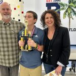 Kyle and Andrea Totten with their son Teddy after he won the Flagler County Spelling Bee at the Buddy Taylor-Wadsworth cafeteria Wednesday evening. (© FlaglerLive)