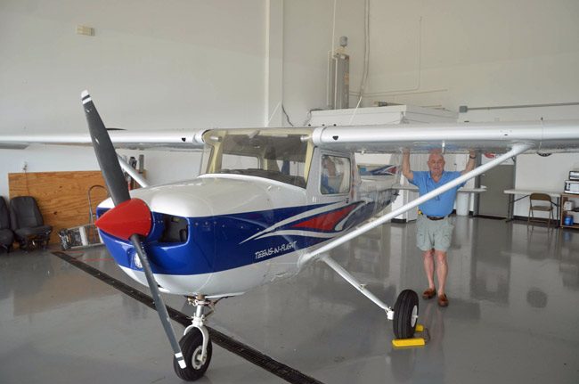 Jack Howell with his beloved Cessna at Teens-In-Flight's new home, co-located with Daytona Aviation at Flagler County Executive Airport. Teens-In-Flight marked the occasion with a ribbon-cutting today. (© FlaglerLive)