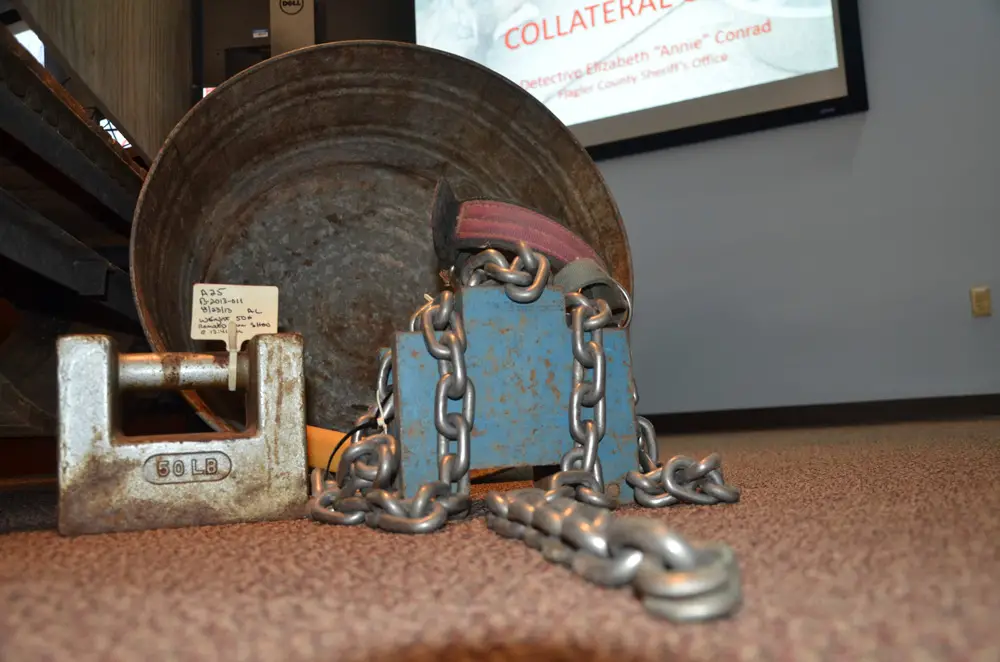 Chains and weights used to tether and 'train' dogs, on display at Flagler County's Emergency Operations Center last November during an ASPCA seminar on animal cruelty. A revised animal ordinance in Flagler bans all such chains, weights or other injurious equipment used on dogs. (© FlaglerLive)