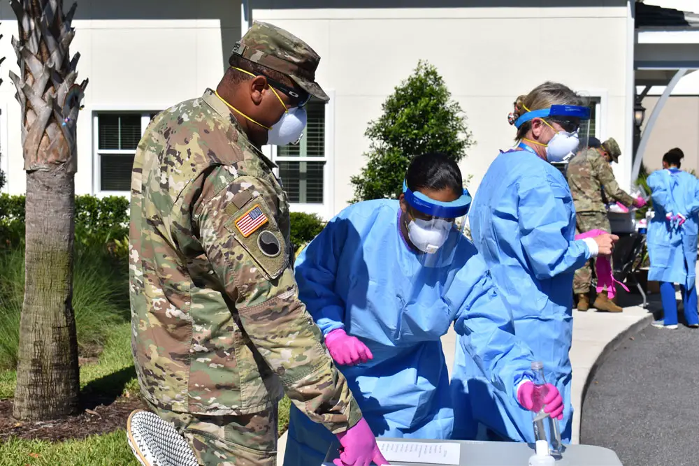 The Flagler Health Department's strike team, including members of the National Guard, at Market Street, the memory care facility in Palm Coast, today. The team conducted some 100 Covid-19 tests of residents and staff there. (© FlaglerLive)