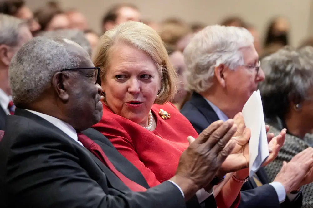 Associate Supreme Court Justice Clarence Thomas sits with his wife, conservative activist Virginia Thomas, at an October 2021 event. (Drew Angerer/Getty Images)