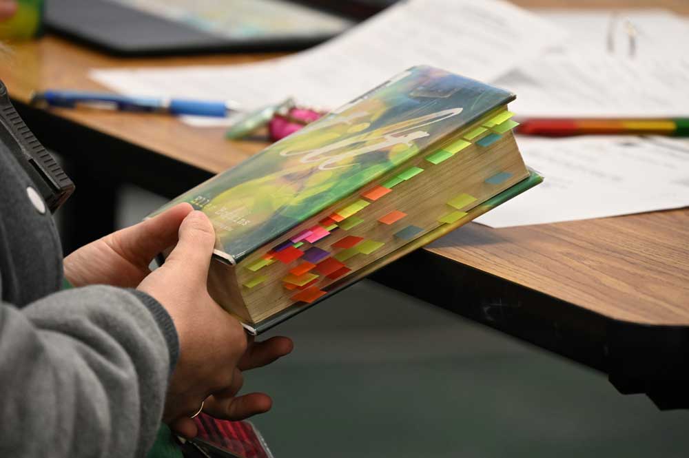 A review committee member with a copy of Ellen Hopkins's "Tilt" this morning at Flagler Palm Coast High School. (© FlaglerLive)