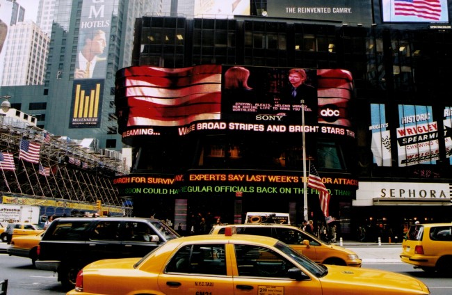 Above, the Times Square ticker in the days immediately after the 9/11 attacks. Below, the Times Square ticker Monday. (© Pierre Tristam/FlaglerLive and Michael Appleton for The New York Times)