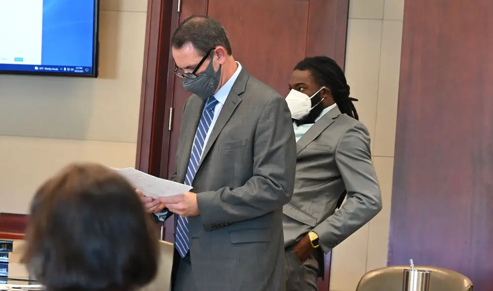 John Hager, left, Deviaun Toler's defense attorney, said Toler had himself been subjected to corporal punishment when he was a child, and was doing the same to his 20-month-old child. The 20 month old was hospitalized for three weeks in critical condition with a skull fracture and a burn to the arm, among other injuries. (© FlaglerLive)