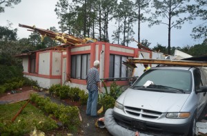 John Coberly, 77, surveys his house, which may be the most demolished of those struck by Sunday's tornado. Click on the image for larger view. (© FlaglerLive)