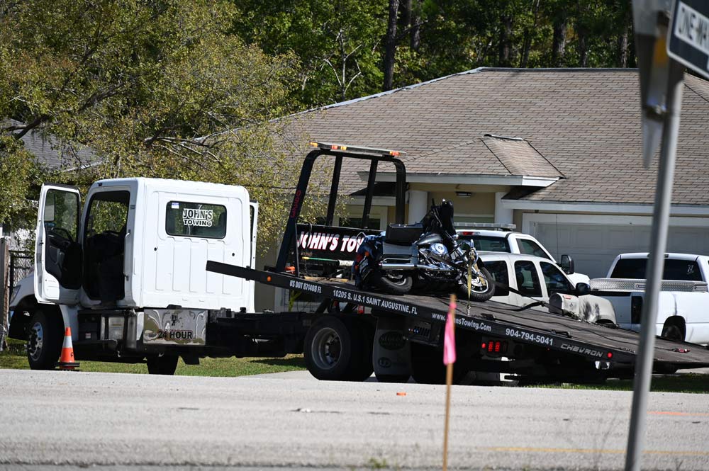 A tow truck took the motorcycle after the crash at U.S. 1 and Karat Path at the edge of Seminole Woods in mid-morning Sunday. Both riders were killed. (© FlaglerLive)