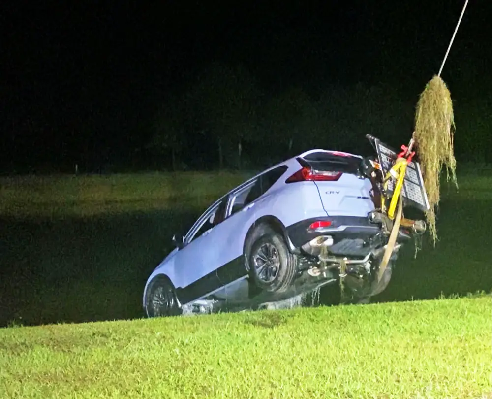 The 2021 Honda SUV getting pulled out of the pond at Grand Reserve in Bunnell last night. (© John's Towing)
