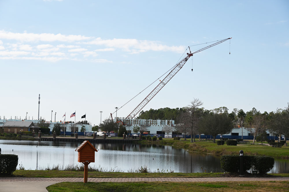 Palm Coast's Town Center is developing, but its chief land holder claims the city has broken its promise of ensuring water and sewer capacity, causing the landowner to lose two sale contracts. Above, construction, last February, at the Promenade, the mixed-use development in Town Center. (© FlaglerLive)