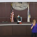 From left, Palm Coast City Manager Matt Morton, Mayor Milissa Holland, and Flagler Health Department Chief Bob Snyder, with an interpreter for the hearing impaired, at today's semi-virtual town hall meeting on Covid-19. (© FlaglerLive via Palm Coast's YouTube Channel)