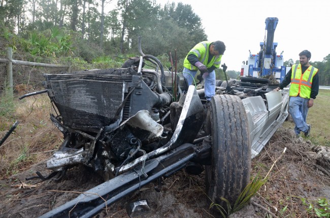 The remains of the trailer, as Roger's Towing's crew worked on it. Click on the image for larger view. (© FlaglerLive)