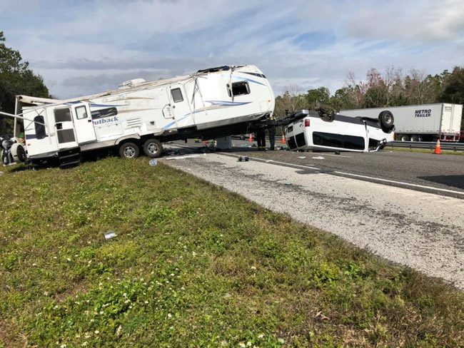 The van towing a large RV flipped, and I-95 southbound was closed at Matanzas Woods Parkway as a result. (Flagler County Professional Firefighters)