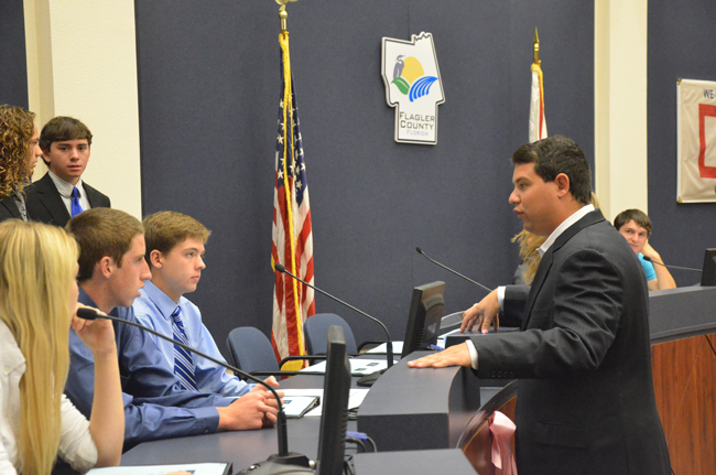 Rep. Travis Hutson conferring with students from Flagler Palm Coast High School and Matanzas High School in October, during an elimination process that led to the animal cruelty bill Hutson filed on Jan. 17. (© FlaglerLive)