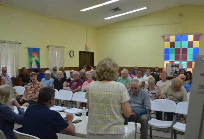 Sue Bickings, right, addresses some 70 people at a meeting of the Sheltering Tree board in Bunnell this afternoon. The meeting was to discuss ideas on countering Bunnell's decision to shut down the cold-weather shelter after 11 years. (c FlaglerLive)
