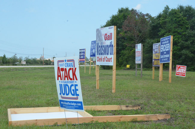 Trey Corbett's sign lies face down after it was defaced by a man who didn't like the way Corbett allegedly treated him at the gym. (© FlaglerLive)