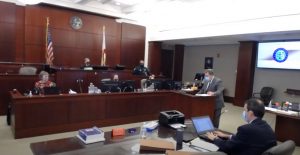 Assistant Public Defender Bill Bookhammer crossexamining a witness. Assistant State Attorney Philip Bavington is in the foreground. Judge Terence Perkins presided. (© FlaglerLive via YouTube)