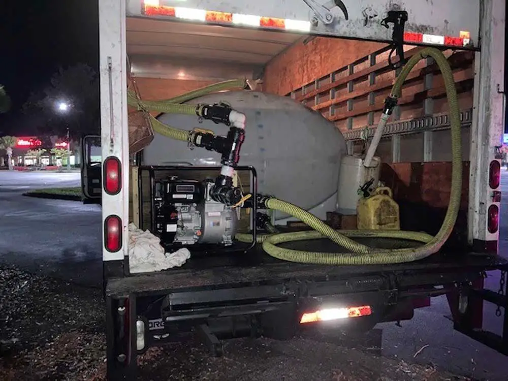 A 1,000-gallon oil drum behind a pump inside the box truck that was used to syphon off used cooking oil in back of Woody's BBQ this morning in Palm Coast. (FCSO)