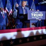 Former president Donald Trump speaks as potential vice presidential hopefuls Vivek Ramaswamy and Sen. Tim Scott look on.