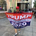 A Trump fan near Trump Tower in Manhattan in June 2019. (© FlaglerLive)